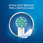 Closeup of round brush head with aqua bristles inside a ring and text highlighting extra soft bristles and a feather