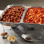 Two EZ Foil steam table pans in chafing dish frames, one filled with meatballs and the other with pasta