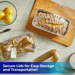Styled overhead scene of glazed lemon loaf cakes in disposable aluminum loaf pans with clear plastic lids and ribbon