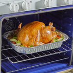 Roasted turkey placed inside an EZ Foil disposable aluminum roasting pan positioned on an oven rack inside a blue oven.