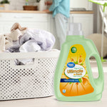 Great Value Ultimate Fresh fabric softener bottle next to a laundry basket of clothes in a home setting