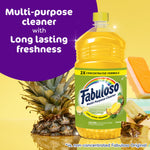 Fabuloso pineapple-scent bottle photographed with fresh pineapple pieces and a cleaning sponge on a bright background.