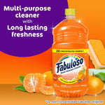 Fabuloso tangerine 2X cleaner bottle with tangerine fruit and sponge on orange backdrop