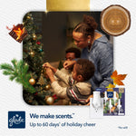Family decorating a Christmas tree in a warm living room scene with a small Glade product and plug-in graphic in the corner.