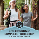 Smiling adult and child walking in wooded area with graphic banner claiming up to 8 hours of protection