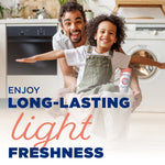 Smiling adult and child in laundry room with laundry basket and Arm & Hammer Light bottle in scene