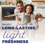 Smiling adult and child in a laundry room with child holding a laundry basket and Arm & Hammer Light product visible
