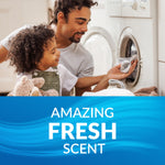 Father and child loading laundry into a washing machine above a blue panel that reads 'Amazing Fresh Scent'