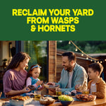 Family enjoying an outdoor meal with headline reclaim your yard from wasps & hornets above them