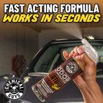 Hand spraying Chemical Guys leather-scent odor eliminator in front of a parked car with headline about fast acting formula