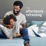 Lifestyle image of a man and child laughing on a couch with overlay text reading effortlessly refreshing
