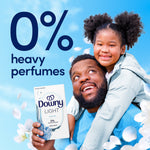 Father giving piggyback ride to a child while holding a Downy Light box with large text stating 0% heavy perfumes