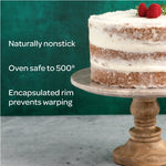 Graphic panel showing a frosted layer cake beside text bullet points highlighting nonstick, oven safe to 500°, and encapsulated rim.