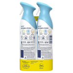 Rear view of two Febreze Air Mist bottles showing product labels, usage icons and safety text on a white background.
