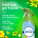 Close-up Febreze Air Mist spray bottle on green background with text describing fresher scent and product benefits