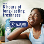 Smiling person on a couch with a Febreze Air Mist bottle and text claiming up to 6 hours of long-lasting freshness