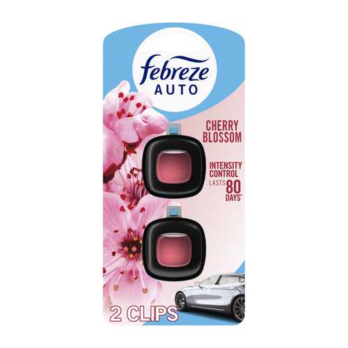 Febreze Auto Cherry Blossom two-pack blister card showing two black vent-clip air fresheners with pink gel centers and floral background.
