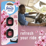 Lifestyle image showing Febreze Auto Cherry Blossom blister pack overlaid beside a smiling driver in a car and floral graphics with 'refresh your ride' text.