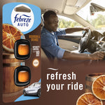 Lifestyle image combining Febreze AUTO Bourbon & Orange packaging at left and a smiling driver in a car interior at right