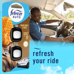 Lifestyle image with Febreze Auto Warm Honey & Musk twin pack packaging at left and a smiling driver in a car at right