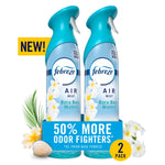 Two Febreze Air Mist Bora Bora Waters spray bottles with promotional 50% more odor fighters badge and tropical flowers