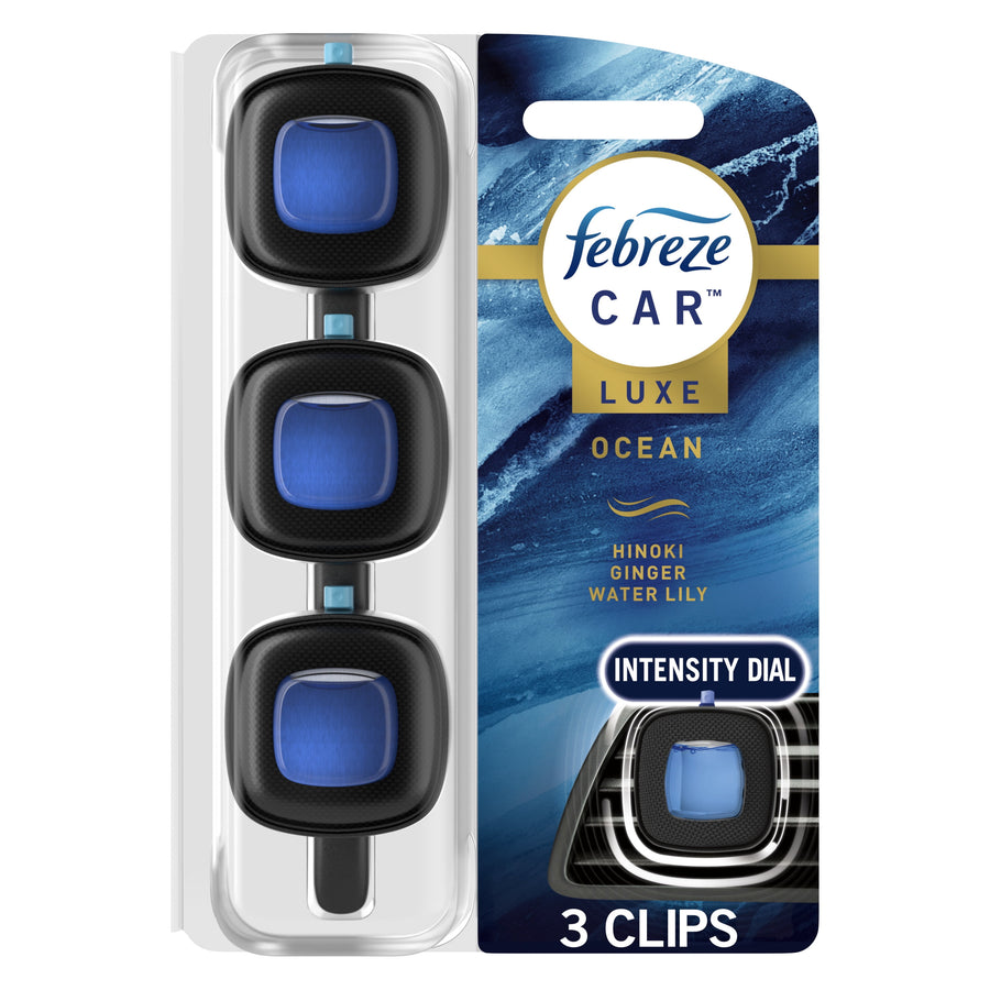 Packaged Febreze Car Luxe Ocean vent-clip trio on blue ocean-themed backing with intensity dial callout