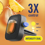 Close-up of a Febreze Car vent clip with intensity dial graphic and pineapple slice on an orange background