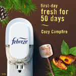 Febreze plug-in device shown on a brown background with pine sprig and toasted marshmallow imagery and 'first-day fresh for 50 days' text
