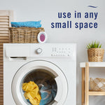 Laundry room scene with a Febreze oval device on top of a washer and copy 'use in any small space'