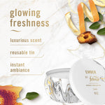 Lifestyle-style graphic showing Febreze Ember candle with marble background and scent callouts