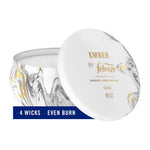Febreze Ember scented candle in marbled tin with lid propped showing four wicks and label