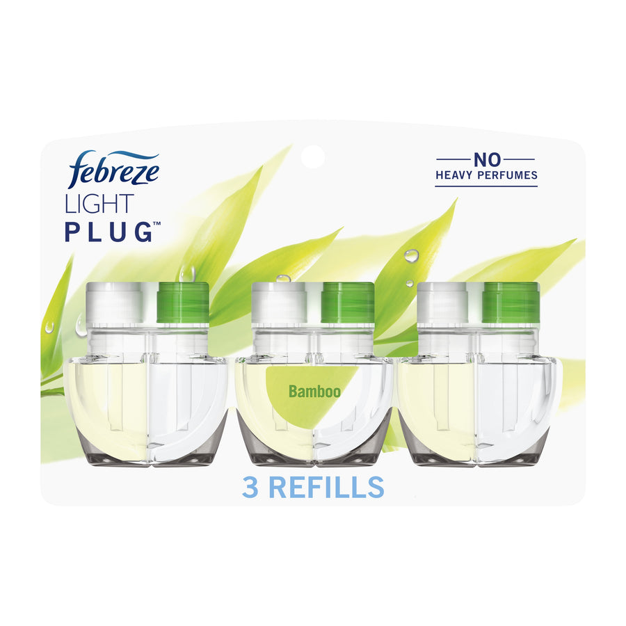 Three Febreze Light Plug refill bottles in clear plastic blister pack with green bamboo graphics