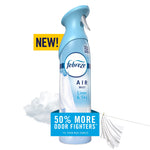 Light blue Febreze Air Mist spray bottle labeled Linen & Sky with cloth and cloud graphics and promotional badge.