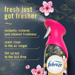 Pink-capped Febreze Luxe spray on dark background with cherry blossom accents and text promoting fresher scent
