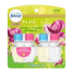 Febreze Luxe plug-in oil refill twin pack on green floral backing labeled Morning Spring Showers.