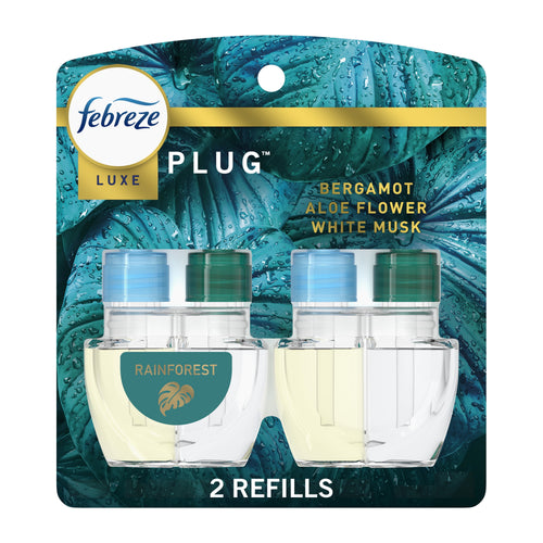 Febreze Luxe Plug refill twin pack on teal rainforest-themed backing showing two clear oil refill bottles and '2 refills' text.
