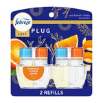 Febreze Luxe plug-in oil refill twin pack on blue packaging showing two clear refill bottles and orange slices.