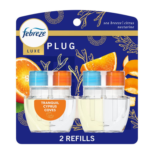 Febreze Luxe plug-in oil refill twin pack on blue packaging showing two clear refill bottles and orange slices.