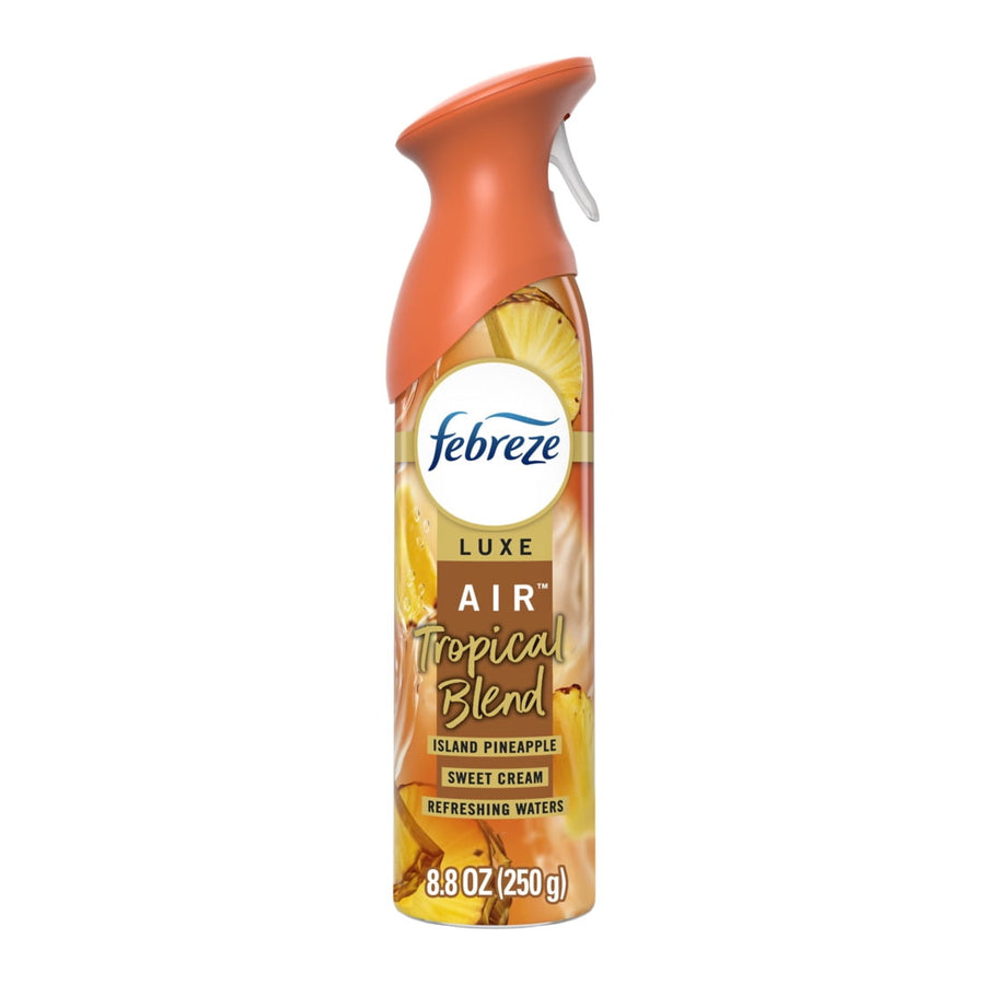 Febreze Luxe Tropical Blend air freshener spray can with orange cap and pineapple label on white background