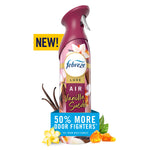 Pink-purple Febreze Luxe air mist spray bottle labeled Vanilla Suede with floral and amber accent and promotional 50% more odor fighters graphic.