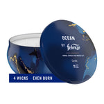Febreze Ocean candle in a navy marbled tin with lid propped open, overlay text banner reading '4 WICKS • EVEN BURN'.