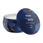 Blue Febreze Ocean scented candle in a round decorative tin with lid showing 'Ocean by Febreze' and three visible wicks.