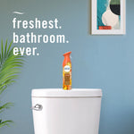 Bathroom scene with Febreze Luxe Tropical Blend can placed on a toilet tank and text ‘freshest. bathroom. ever.’