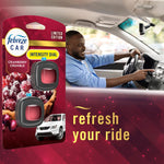 Lifestyle image showing Febreze Car cranberry crumble packaging superimposed beside a smiling driver inside a car