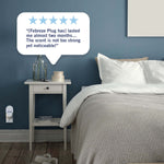 Bedroom scene with a nightstand and a small Febreze plug-in device on the wall and a five-star customer quote bubble