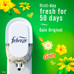Febreze plug shown on a green Gain-themed background with flowers and text claiming first-day fresh for 50 days