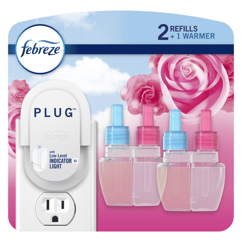 Febreze plug-in starter warmer and three replacement scented oil refill bottles on floral pink background