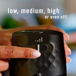 Top view close-up of Febreze PLUG unit showing fingertip adjusting a slider with text low, medium, high or off