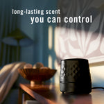 Black Febreze PLUG scent booster placed on a table in a styled room with text about long-lasting scent control