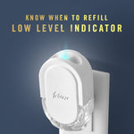Febreze plug-in device plugged into wall with glowing low-level indicator and explanatory text